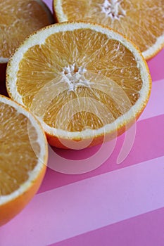 juicy oranges on a pink table, vitamins, citruses, textured table background, abstract background, nature, ripe bright oranges