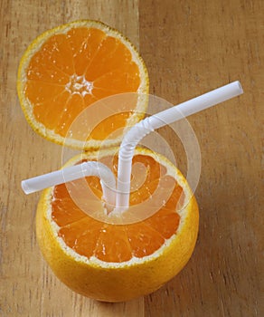 Juicy oranges with tubes for a cocktail.
