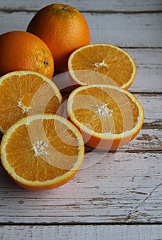 Juicy oranges on a white wooden table, orange texture, vitamins, citruses, textured background of the table