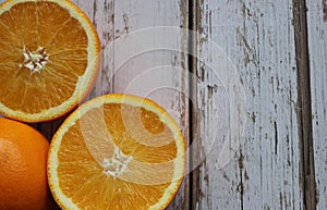 Juicy oranges on a white wooden table, orange texture, vitamins, citruses, textured background of the table