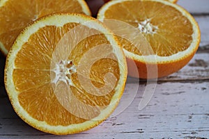 Juicy oranges on a white wooden table, orange texture, vitamins, citruses, textured background of the table, macro