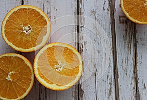 Juicy oranges on a white wooden table, orange texture, vitamins, citruses, textured background of the table, macro