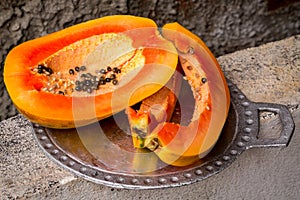 Juicy papaya on a metal tray