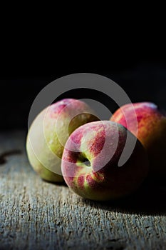 Juicy peaches in old wooden tray