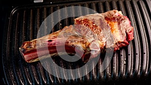 Juicy piece of beef steak on a grill seasoned with spices