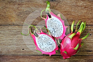 Juicy pink pitaya on wooden table