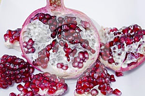 Juicy pomegranate cut in half on white background