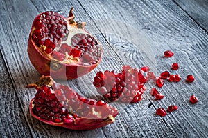 Juicy pomegranate fruit over wooden table