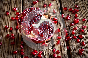 Juicy pomegranate fruit over wooden table