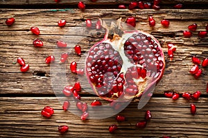 Juicy pomegranate fruit over wooden table