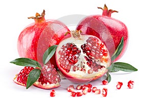 Juicy pomegranate and its half with leaves