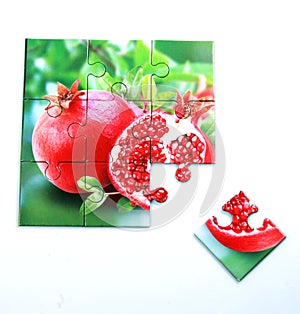 Juicy pomegranate and its half with leaves photo on puzzle boards