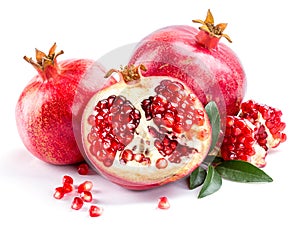 Juicy pomegranate and its half with leaves