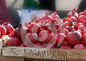 Juicy pomegranates in a box on the market