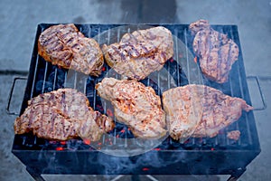 Juicy Pork steak Barbecue on Grill with hot coals