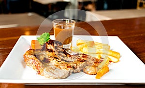 Juicy porkchop on white plate