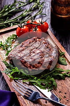 Juicy portions of grilled fillet steak served with tomatoes and