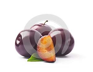 Juicy purple Plum fruits with cut in half and green leaf isolated on white background.