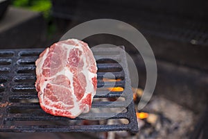 Juicy raw steak on barbecue background outdoor