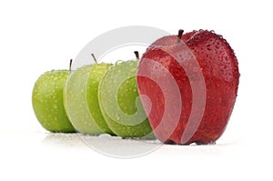 Juicy red apple in stack of green apple