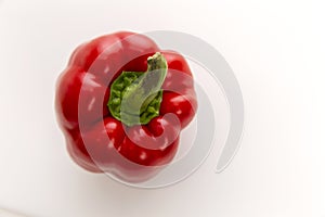 Juicy red bell pepper on a white background. Diet vegetarian food. Top view