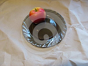 Juicy red florina apple on a black plate