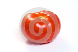 Juicy red tomato on a white isolated background