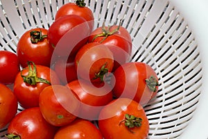 Juicy red tomatoes in table cloth . caro background photo