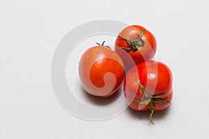 Juicy red tomatoes in table cloth . caro background photo