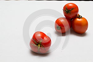 Juicy red tomatoes in table cloth . caro background photo