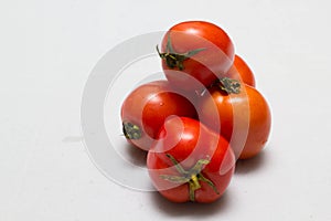 Juicy red tomatoes in table cloth . caro background photo