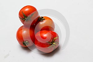 Juicy red tomatoes in table cloth . caro background photo