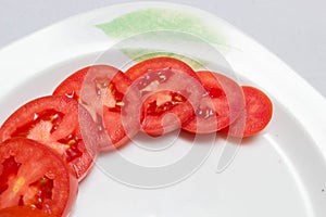 Juicy red tomatoes in table cloth . caro background photo