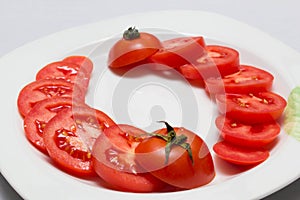 Juicy red tomatoes in table cloth . caro background photo