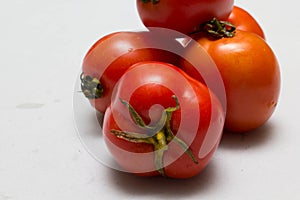 Juicy red tomatoes in table cloth . caro background photo