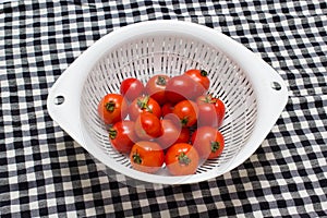 Juicy red tomatoes in table cloth . caro background photo