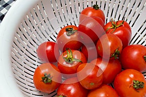 Juicy red tomatoes in table cloth . caro background photo