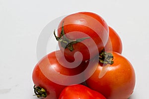 Juicy red tomatoes in table cloth . caro background photo