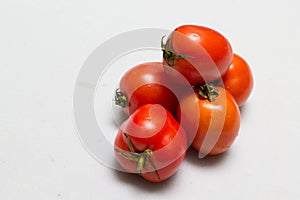 Juicy red tomatoes in table cloth . caro background photo