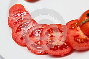 Juicy red tomatoes in table cloth . caro background photo