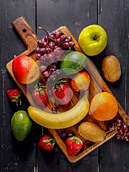 Juicy ripe fruits. Strawberry, kiwi, apple, pear, banana, avocado, grape. Assorted delicious tropical fruits
