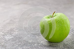 Juicy ripe green Apple with water drops