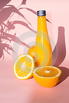 Juicy ripe oranges on a light pink background. Creative food concept. Tropical organic fruits, citrus, vitamin C.