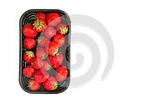 Ripe strawberry in black container on white background