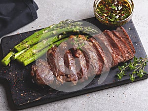 Juicy roasted beef chopped steak, mutton with asparagus, close up, sauce