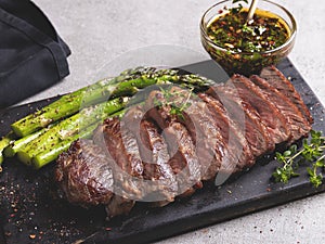 Juicy roasted beef chopped steak, mutton with asparagus, close up, sauce