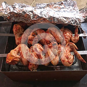 Juicy roasted Ñhicken wings on the skewered barbecue