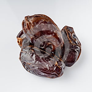 Juicy royal dates on a white acrylic background