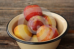 Juicy seasonal plums on the table macro