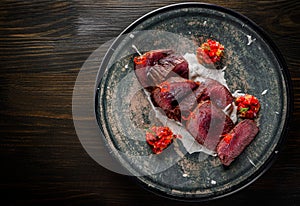 Juicy sliced steak medium rare beef in plate on wooden table